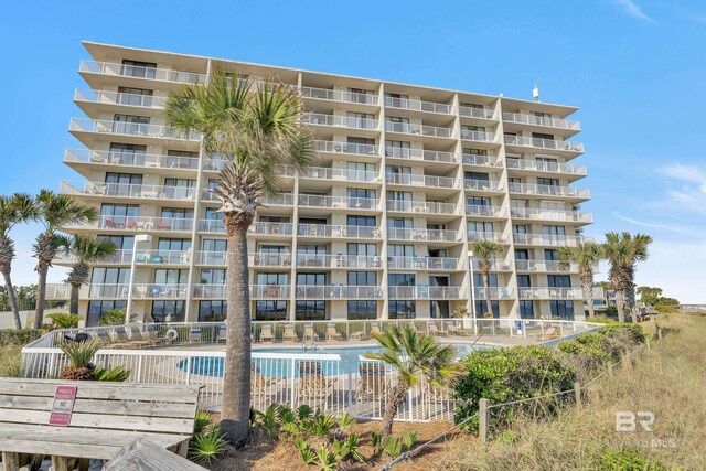 24522 Perdido Beach Blvd Unit 3705, Orange Beach, AL 36561 - view of property featuring a community pool and fence