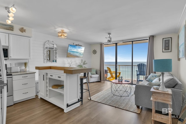 24522 Perdido Beach Blvd Unit 3705, Orange Beach, AL 36561 - kitchen with white cabinets, open shelves, a water view, open floor plan, and wood finished floors