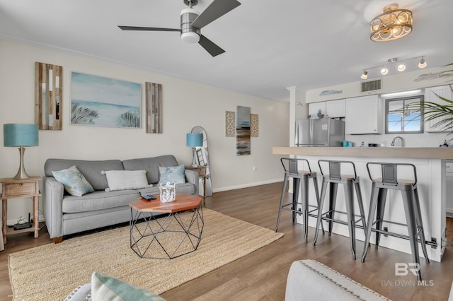 24522 Perdido Beach Blvd Unit 3705, Orange Beach, AL 36561 - living room with ceiling fan, ornamental molding, visible vents, wood finished floors, and baseboards