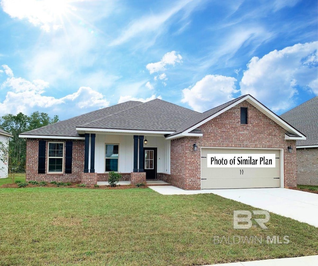 12661 Wagner Ave, Spanish Fort, AL 36527 - view of front facade featuring brick siding, an attached garage, covered porch, driveway, and a front yard
