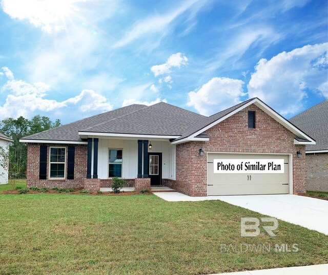 12661 Wagner Ave, Spanish Fort, AL 36527 - view of front facade featuring brick siding, an attached garage, covered porch, driveway, and a front yard
