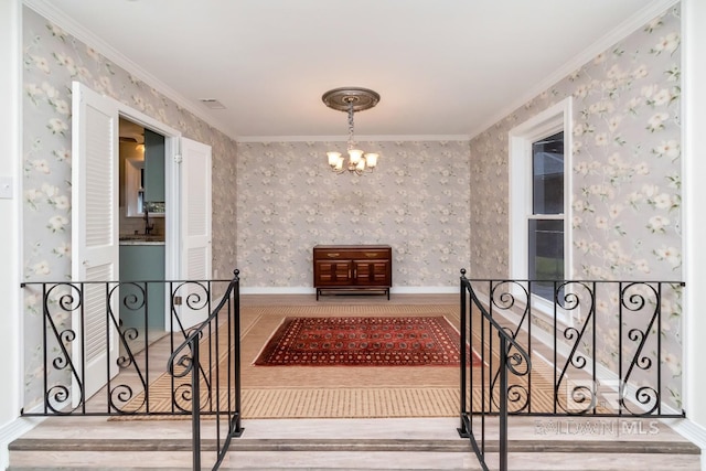 interior space featuring crown molding, hardwood / wood-style flooring, and a notable chandelier