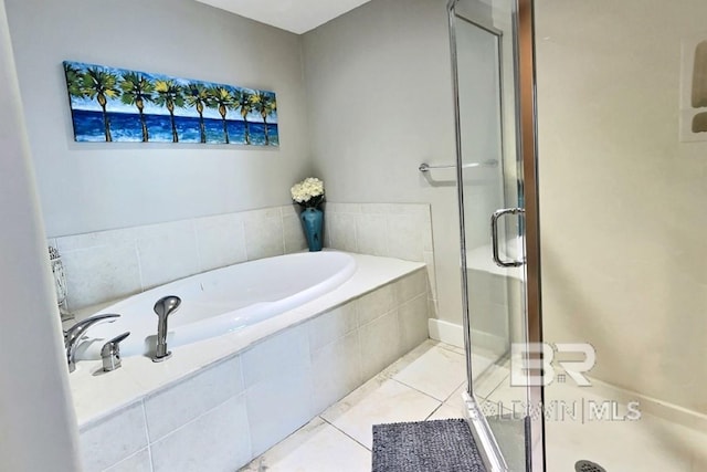 521 W Beach Blvd Unit 1703, Gulf Shores, AL 36542 - bathroom featuring tile patterned floors, a shower stall, and a garden tub