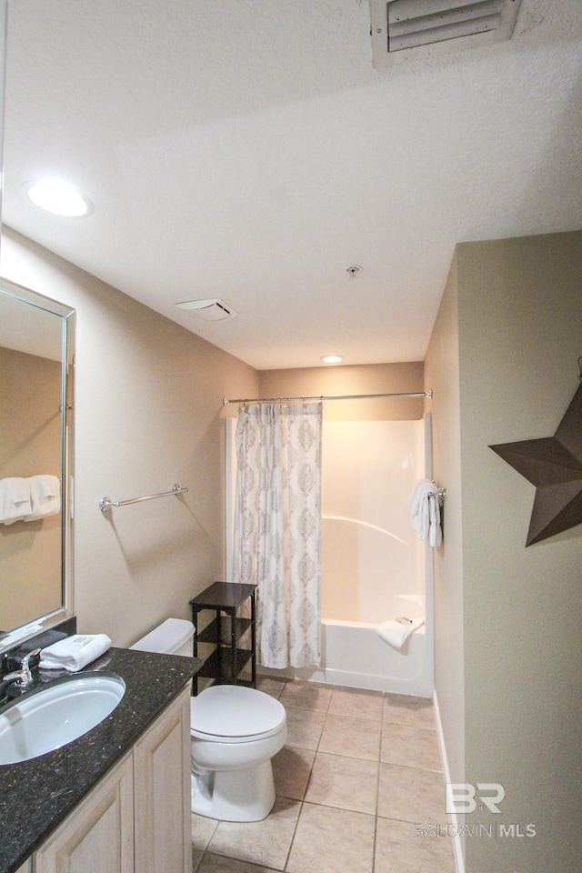 full bathroom featuring shower / bath combination with curtain, tile patterned floors, vanity, and toilet