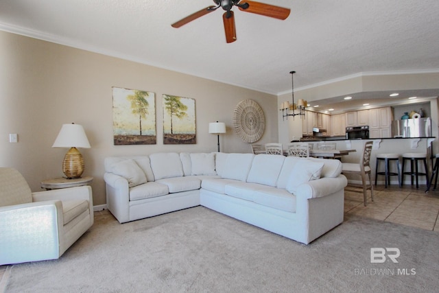 living room with a textured ceiling, ceiling fan with notable chandelier, ornamental molding, and light carpet