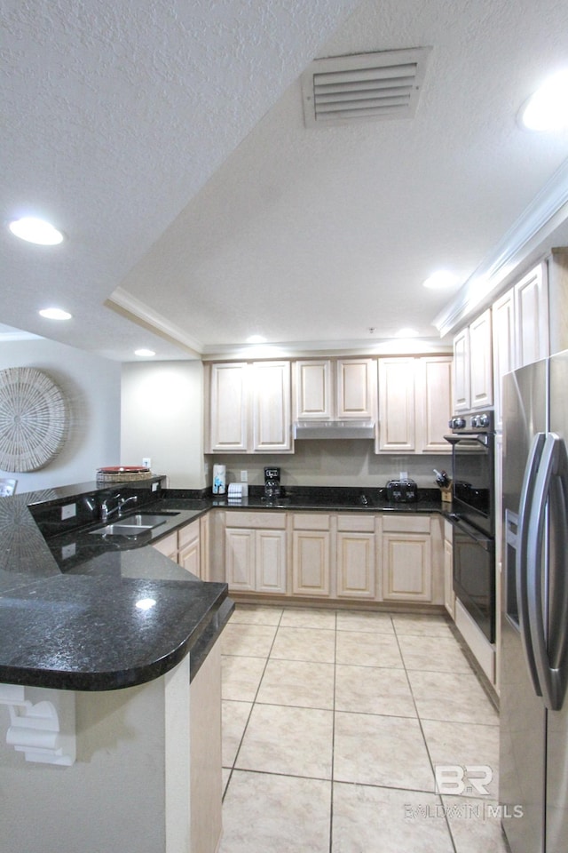 kitchen featuring a textured ceiling, sink, stainless steel refrigerator with ice dispenser, kitchen peninsula, and double oven