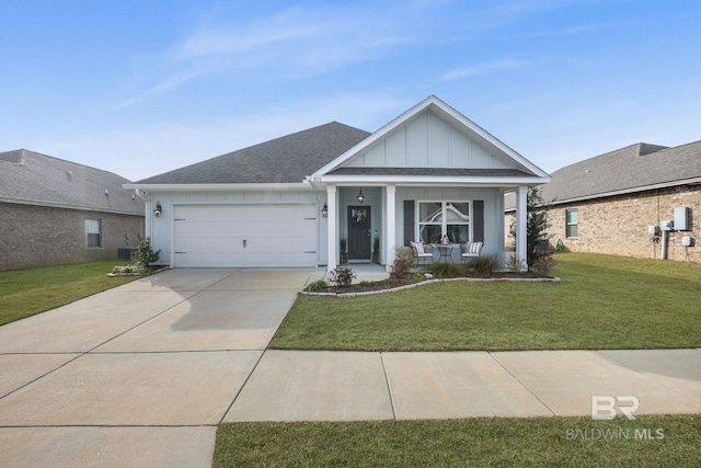 view of front of home featuring a garage, covered porch, and a front lawn