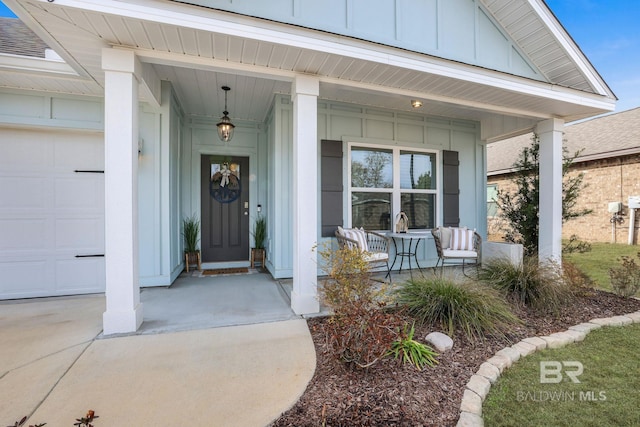 view of exterior entry with a porch