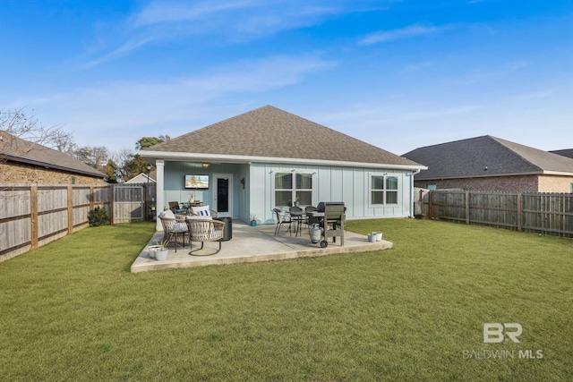 rear view of property with a yard and a patio