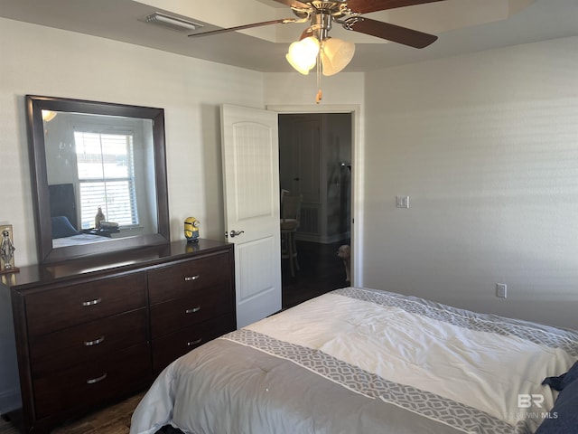 bedroom with ceiling fan and dark hardwood / wood-style floors