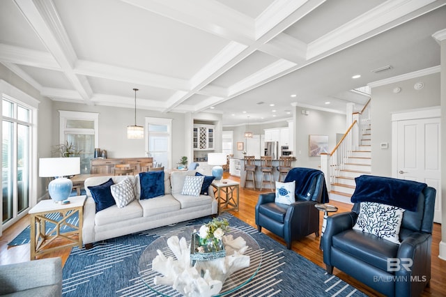 living room with wood-type flooring, beamed ceiling, coffered ceiling, and ornamental molding