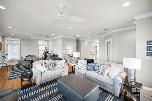 living room with ceiling fan, ornamental molding, and hardwood / wood-style flooring