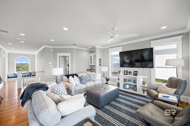 living room with light hardwood / wood-style floors, plenty of natural light, and ceiling fan