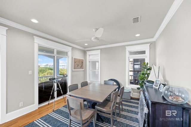 dining room with ceiling fan, crown molding, and hardwood / wood-style flooring