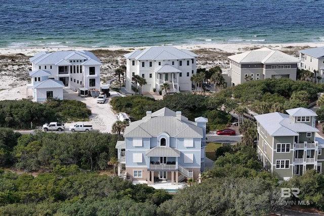 drone / aerial view featuring a beach view and a water view