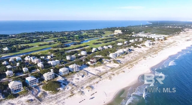 drone / aerial view featuring a beach view and a water view