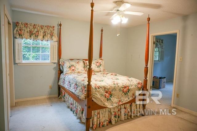 carpeted bedroom featuring baseboards and ceiling fan
