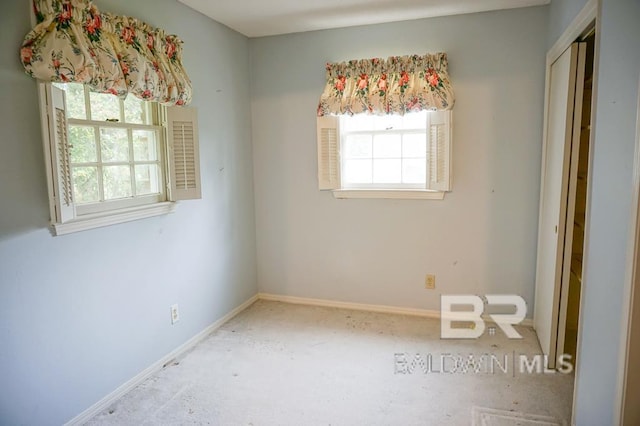 spare room featuring baseboards and a healthy amount of sunlight