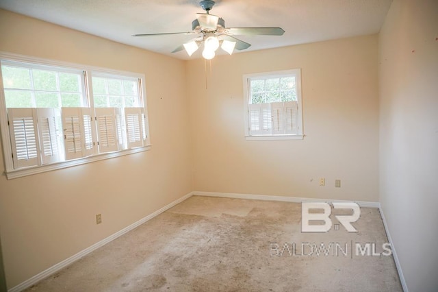spare room featuring carpet flooring, baseboards, and ceiling fan