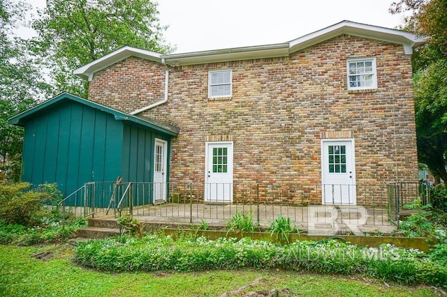 rear view of house featuring board and batten siding