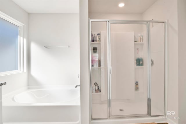 bathroom featuring plus walk in shower