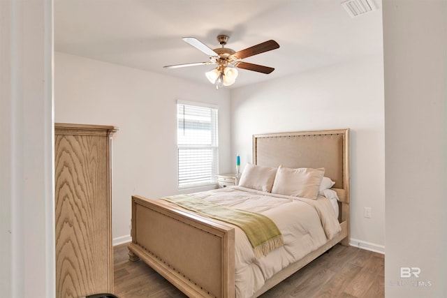 bedroom with ceiling fan and wood-type flooring