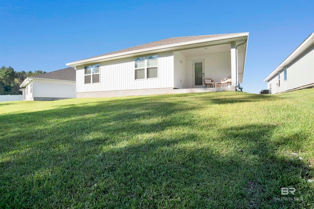 rear view of house with a yard