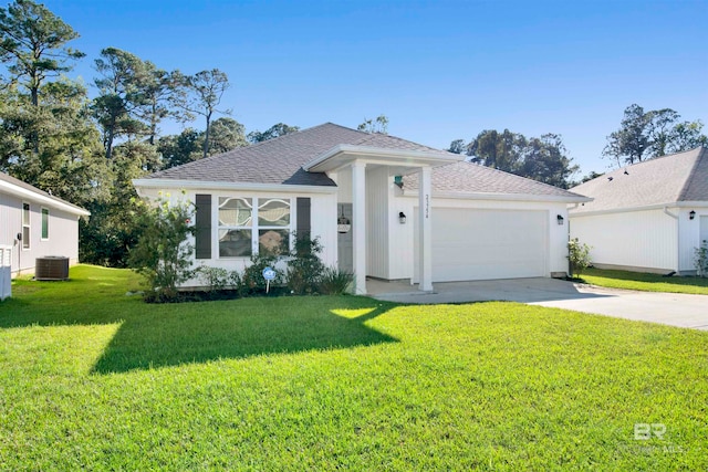 view of front of property with central AC, a front lawn, and a garage