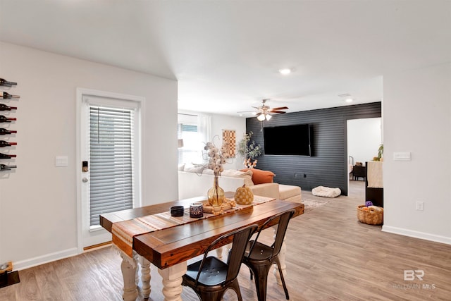 dining area featuring ceiling fan and light wood-type flooring