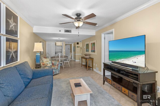 24132 Perdido Beach Blvd Unit 1063, Orange Beach, AL 36561 - tiled living room with ceiling fan, baseboards, ornamental molding, and visible vents