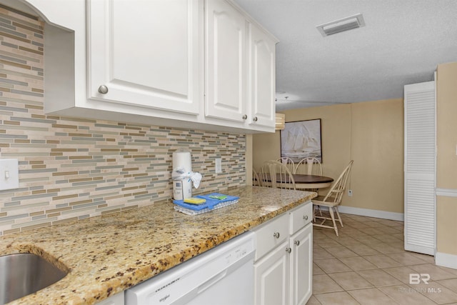 24132 Perdido Beach Blvd Unit 1063, Orange Beach, AL 36561 - kitchen featuring white cabinets, tasteful backsplash, visible vents, dishwasher, and light tile patterned floors