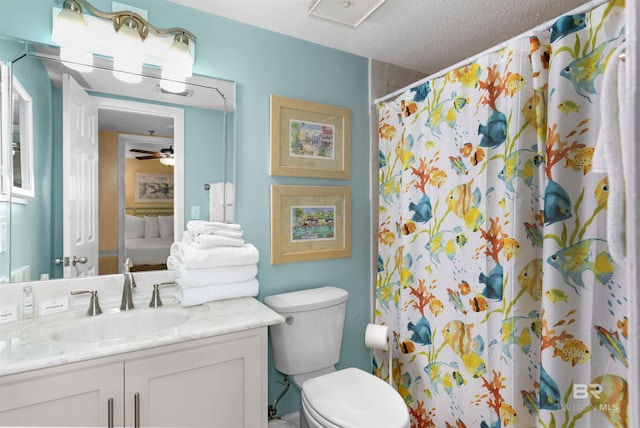 24132 Perdido Beach Blvd Unit 1063, Orange Beach, AL 36561 - bathroom featuring a ceiling fan, a textured ceiling, vanity, a shower with curtain, and toilet