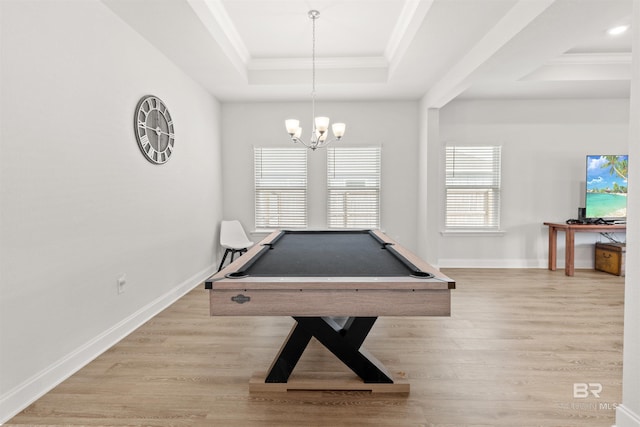 rec room featuring pool table, a notable chandelier, light hardwood / wood-style floors, a tray ceiling, and crown molding