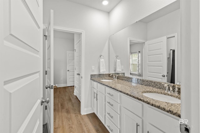 bathroom with hardwood / wood-style flooring and vanity