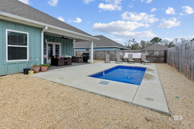 view of swimming pool featuring french doors, ceiling fan, grilling area, and a patio area