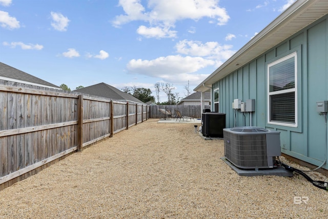 view of yard featuring central AC unit and a patio