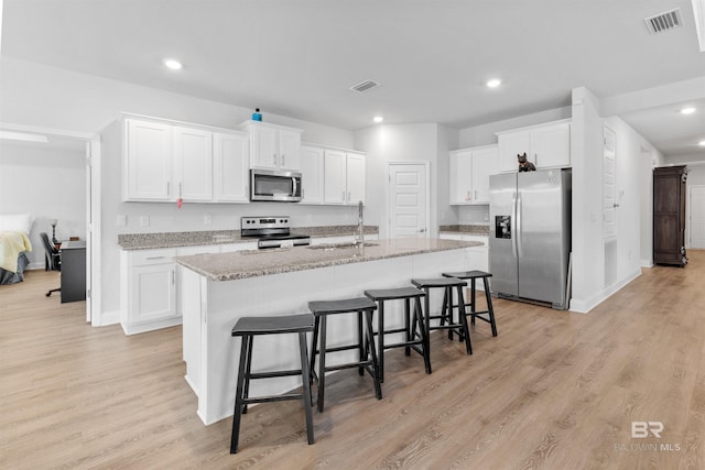 kitchen featuring appliances with stainless steel finishes, sink, and white cabinets