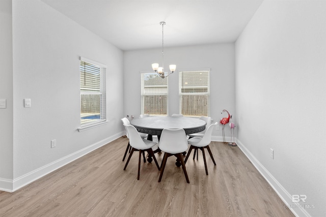 dining area featuring an inviting chandelier and light hardwood / wood-style floors