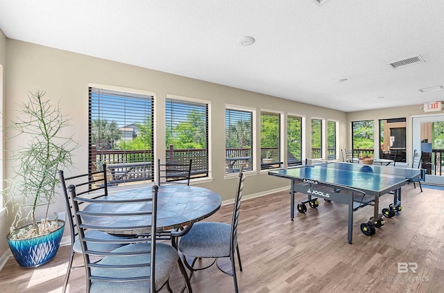 rec room with light hardwood / wood-style floors
