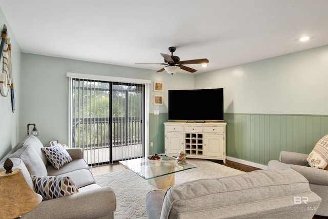 living room with ceiling fan and light wood-type flooring