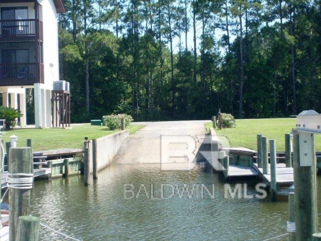 view of dock featuring a yard and a water view