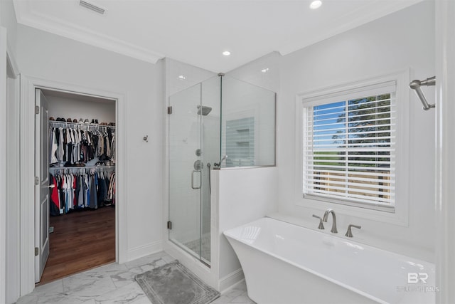 bathroom featuring ornamental molding and plus walk in shower