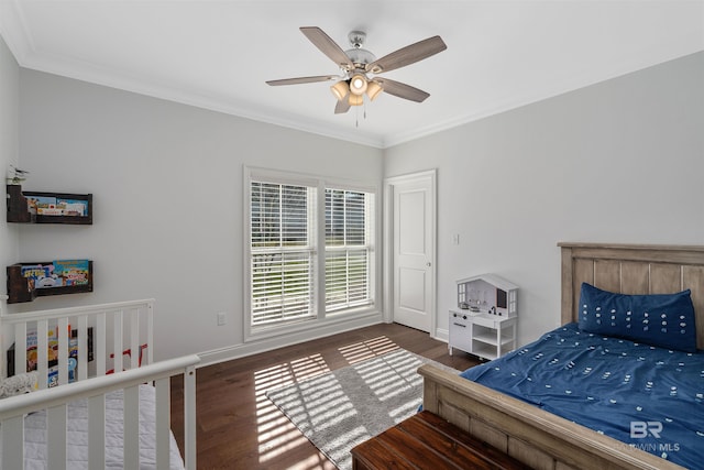 bedroom featuring ornamental molding, dark hardwood / wood-style floors, and ceiling fan