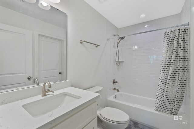 full bathroom featuring shower / tub combo, vanity, and toilet