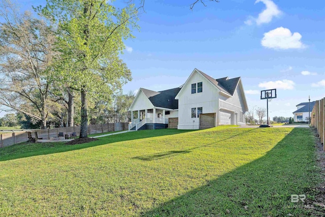 exterior space featuring a porch, a garage, and a yard