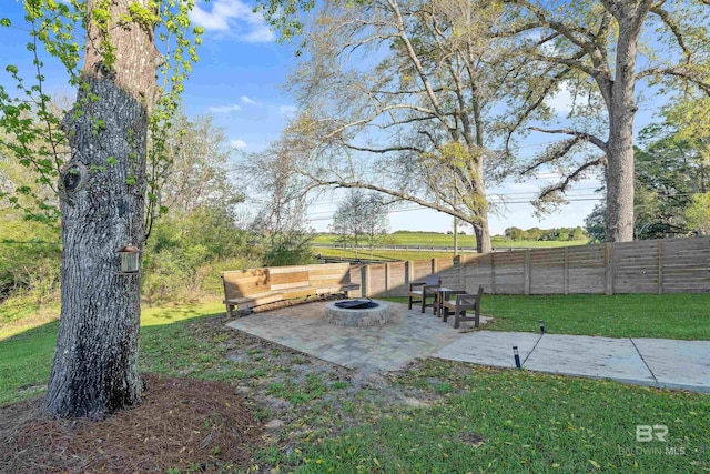 view of yard featuring a patio area, a fire pit, and a rural view