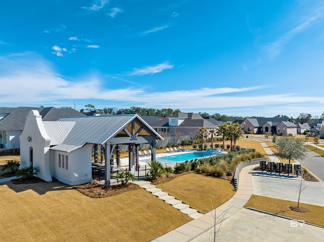 view of pool with a lawn