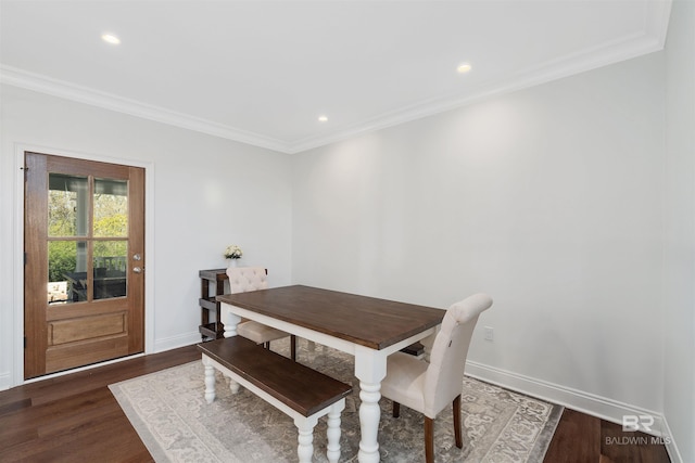 dining space with crown molding and dark wood-type flooring