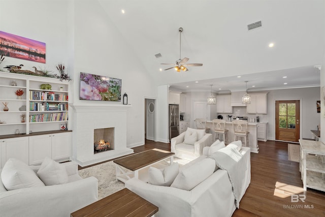 living room with crown molding, ceiling fan, high vaulted ceiling, a fireplace, and dark hardwood / wood-style flooring