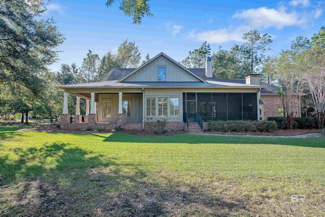 view of front of house featuring a front lawn and a sunroom